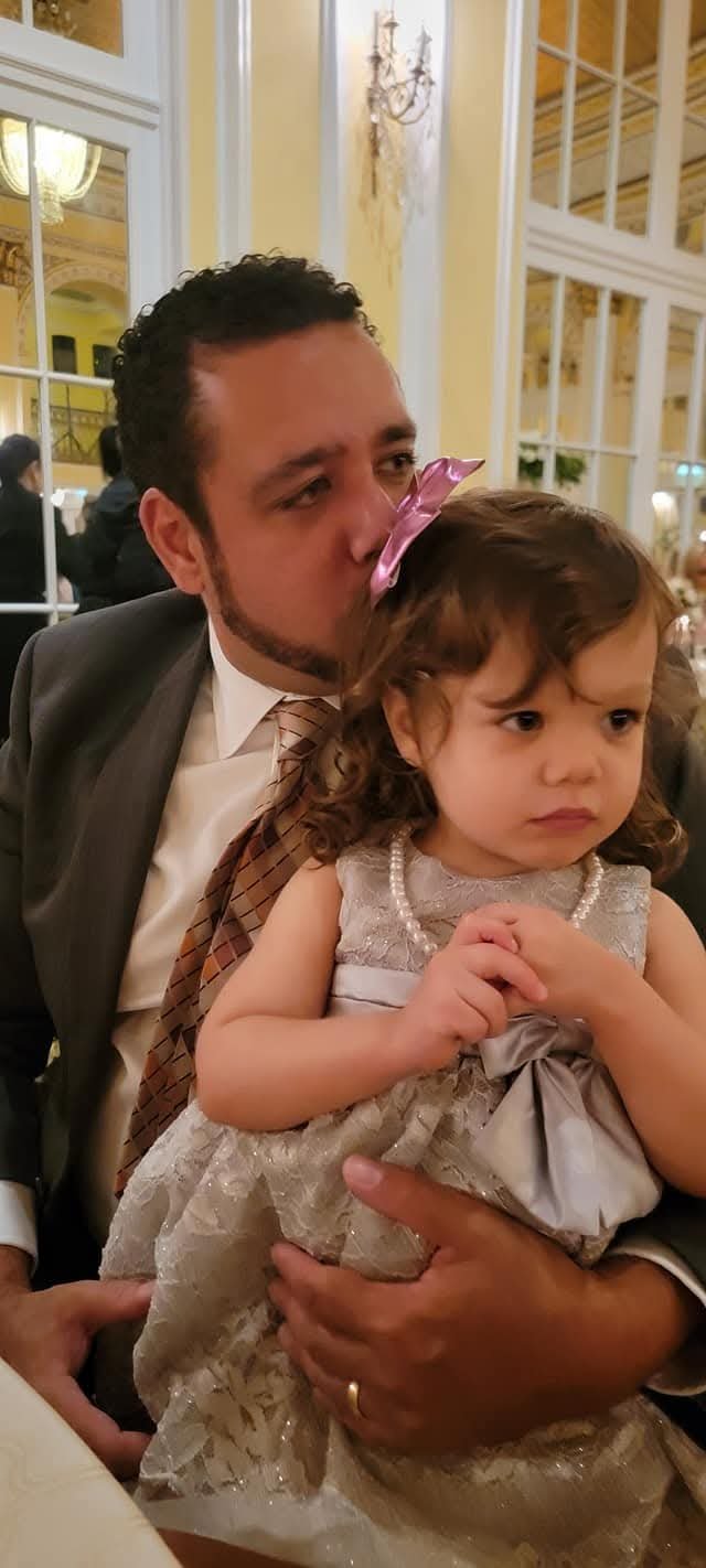 Dad kissing his daughter at a formal dinner