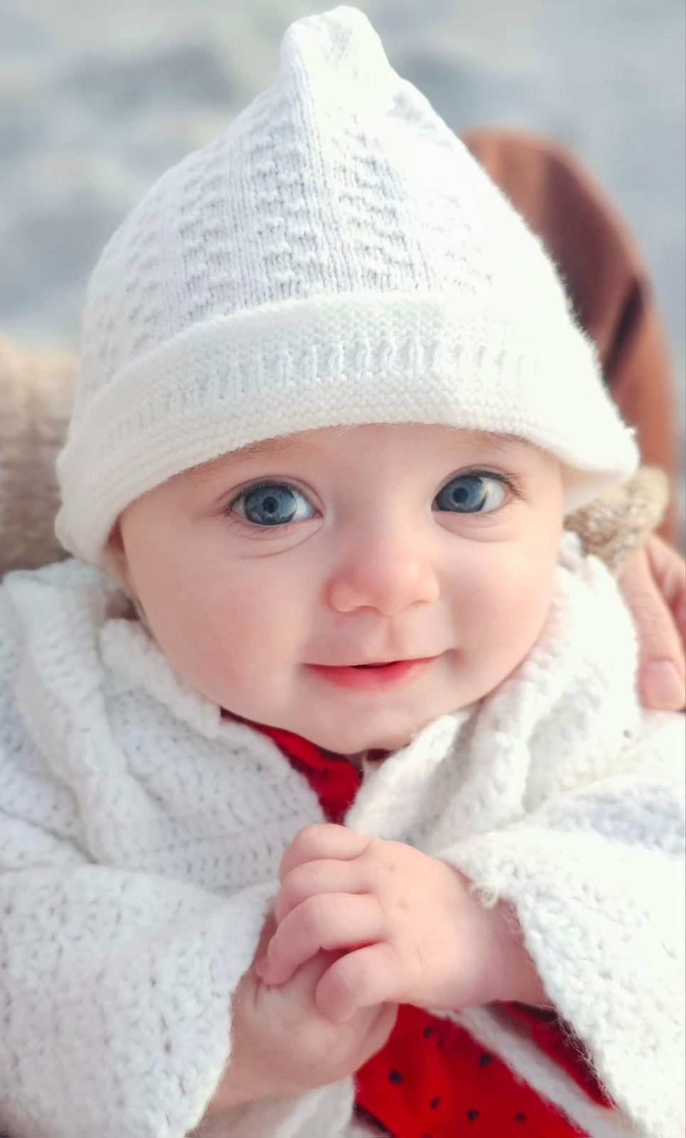 Baby in a white knit hat