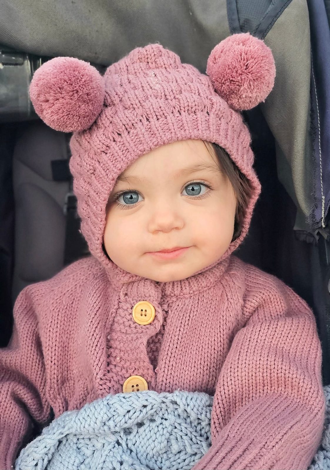 Baby in a pink pom-pom hat
